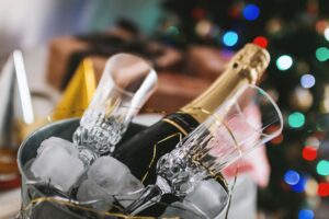 Bottle of champagne and 2 glasses in a bucket of ice