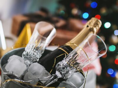 Bottle of champagne and 2 glasses in a bucket of ice